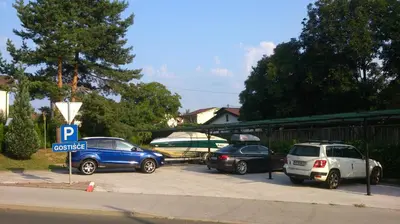 a group of cars parked in a parking lot at Garni Hotel & Apartments Terano in Maribor