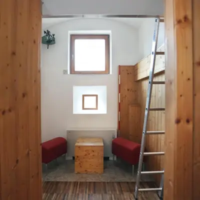 a room with two bunk beds and a ladder at Hostel Celica in Ljubljana