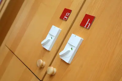 two whiteintendo wii controllers on a wooden floor at Hostel Celica in Ljubljana