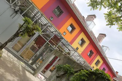 a colorful building with glass windows on it at Hostel Celica in Ljubljana