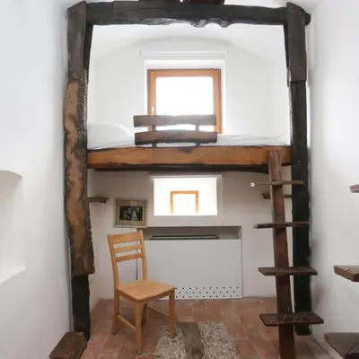 a room with a bunk bed and a chair at Hostel Celica in Ljubljana