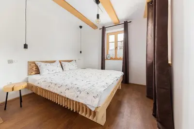 a bedroom with a bed and a window at Hiša na soncu / Sun house in Zgornje Gorje