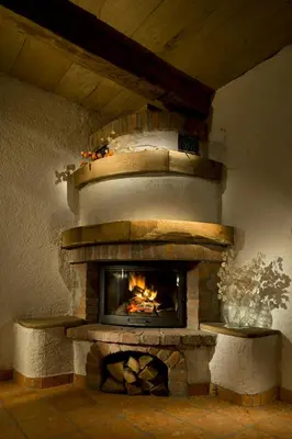 a brick fireplace with a fire in it at Domačija Šeruga Countryside hotel in Novo Mesto