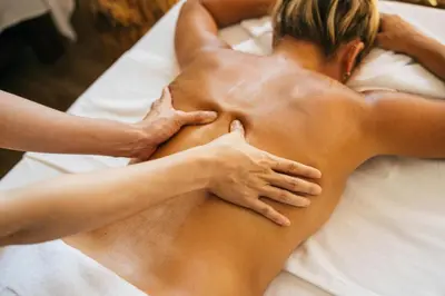 a woman getting a massage at a spa at Domačija Šeruga Countryside hotel in Novo Mesto