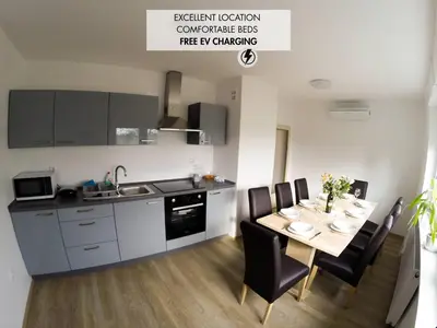 a kitchen and dining room with a table and chairs at Apartments Andrej - Poetovio & Ptuj in Ptuj