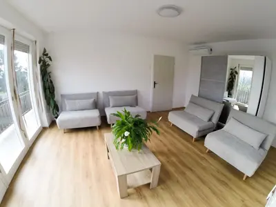 a living room with two couches and a table at Apartments Andrej - Poetovio & Ptuj in Ptuj