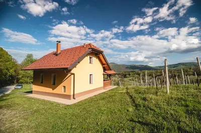 a small house with a red roof in a field at Holiday Home Blue Sky in Globocice