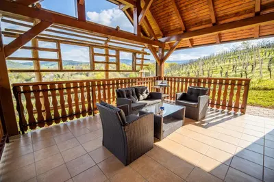 a screened in porch with chairs and a table at Holiday Home Blue Sky in Globocice