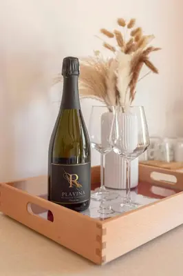 a bottle of wine and two glasses on a wooden tray at Ražman Wine Rooms in Gračišče