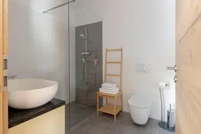 a bathroom with a tub and a sink and a toilet at Ražman Wine Rooms in Gračišče