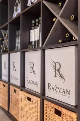 a shelf with bottles of wine and baskets at Ražman Wine Rooms in Gračišče