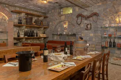 a dining room with a table with wine bottles at Ražman Wine Rooms in Gračišče