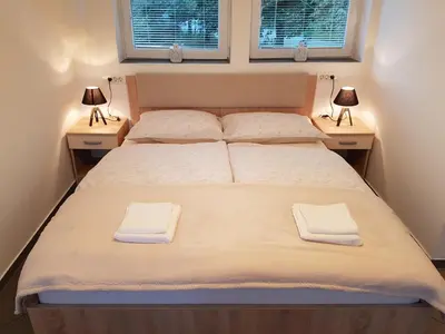 a bedroom with a bed with two towels on it at 4 seasons apartment Radovljica in Radovljica