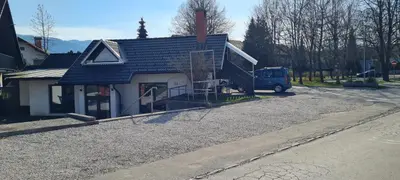 a blue van parked in front of a house at 4 seasons apartment Radovljica in Radovljica