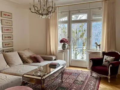 a living room with a couch and a table and a window at Adora Luxury Hotel in Bled