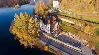 an aerial view of a building next to a lake at Adora Luxury Hotel in Bled