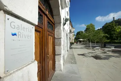 a door to a building with a sign on it at Galeria River in Ljubljana