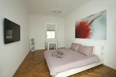 a living room with a white couch and a flat screen tv at Galeria River in Ljubljana