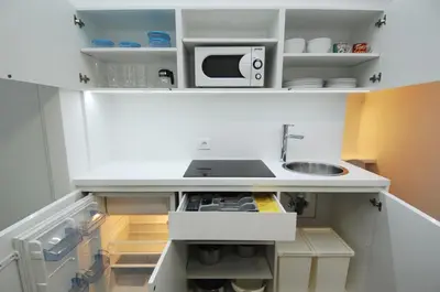 a kitchen with a sink and a microwave at Galeria River in Ljubljana