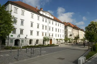 a large white building on the side of a street at Galeria River in Ljubljana