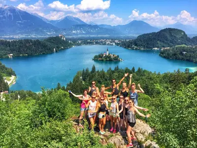 a group of people standing on a mountain overlooking a lake at Youth Hostel Bledec in Bled