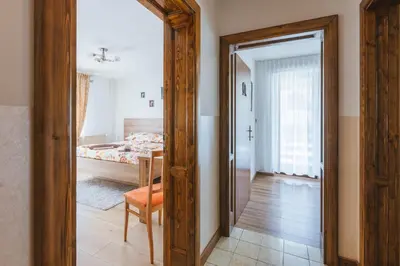 a mirror in a room with a bed and a bedroom at Rooms Zupančič in Bohinjska Bela