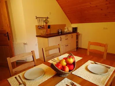 a kitchen with a table with a bowl of fruit on it at Tourist Farm 