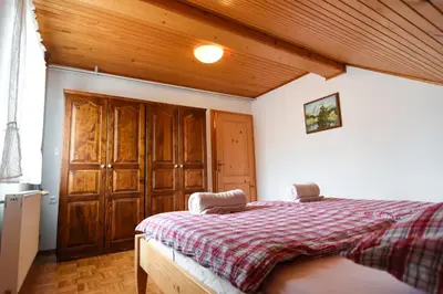 a bedroom with a bed and a wooden ceiling at Tourist Farm 