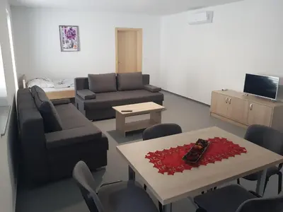 a living room with a couch and a table at Apartmaji Janković in Logatec