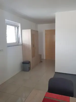 an empty room with a window and a door at Apartmaji Janković in Logatec