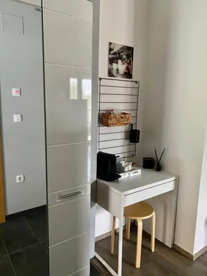 a white desk with a chair next to a cabinet at LizMari in Podčetrtek