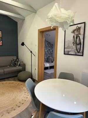 a living room with a white table and chairs at LizMari in Podčetrtek