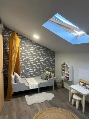 a room with a bed and a skylight at LizMari in Podčetrtek