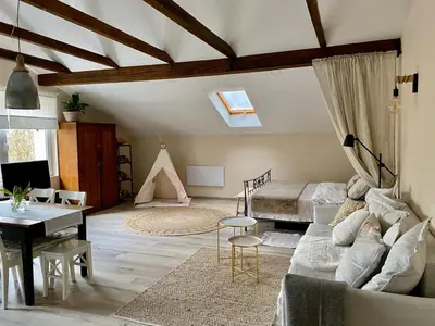 a living room with a couch and a desk at LizMari in Podčetrtek