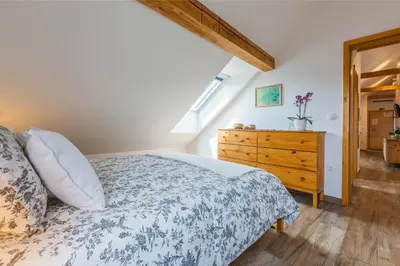 a bedroom with a bed and a wooden dresser at Pr'Jernejc Agroturism in Lesce