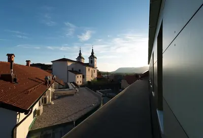 a view of a city with buildings and a church at Postojna Cave Rooms & Apartments Proteus in Postojna
