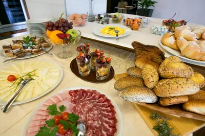 a table topped with lots of different types of food at Postojna Cave Rooms & Apartments Proteus in Postojna