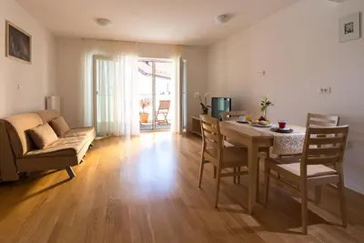 a living room with a table and a couch at Postojna Cave Rooms & Apartments Proteus in Postojna