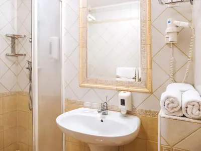 a bathroom with a sink and a mirror and towels at Rooms Reaktiv in Zreče