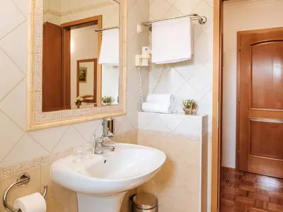 a bathroom with a sink and a mirror at Rooms Reaktiv in Zreče