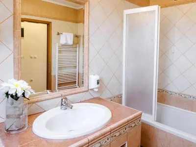 a bathroom with a sink and a mirror at Rooms Reaktiv in Zreče