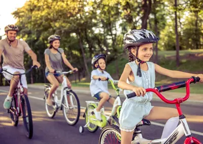 a group of people riding bikes down a street at Rooms Reaktiv in Zreče