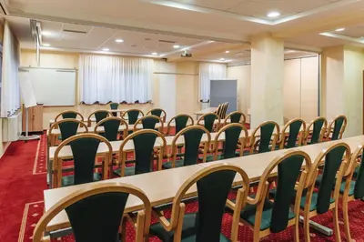 a conference room with a long table and chairs at Rooms Reaktiv in Zreče