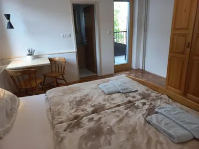 a bedroom with a large bed with two towels on it at Sobe Levc in Mozirje