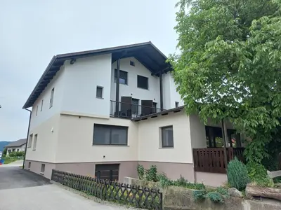 a white building with a black roof at Sobe Levc in Mozirje