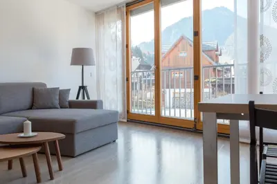 a living room with a couch and a table at Auredius Deluxe Apartment in Kranjska Gora