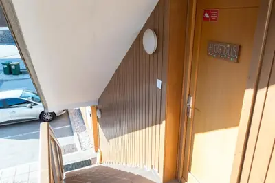 an overhead view of a building with a car parked in a parking lot at Auredius Deluxe Apartment in Kranjska Gora