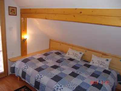 a bedroom with a bed with a checkered comforter at Apartments Lana in Bled