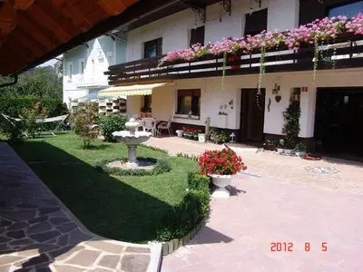 a courtyard of a building with flowers and a fountain at Apartments Lana in Bled