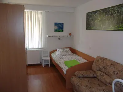 a small living room with a couch and a bed at Apartments Lana in Bled